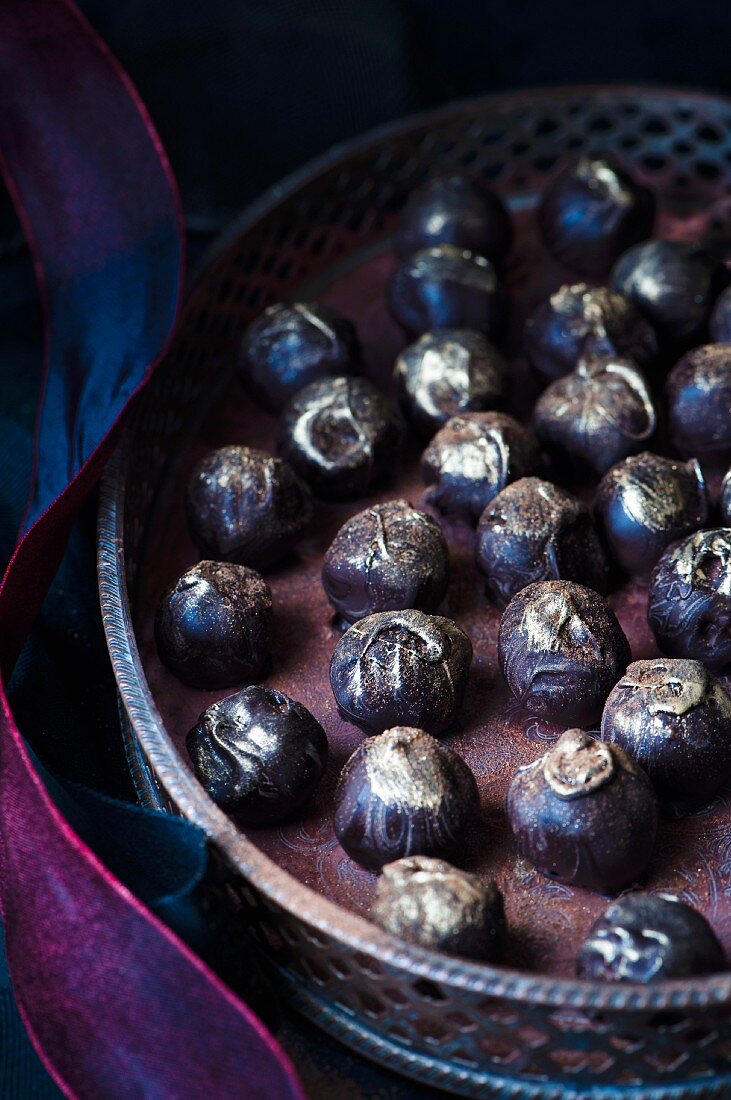 Homemade dark chocolate truffle sprinkled with edible gold powder