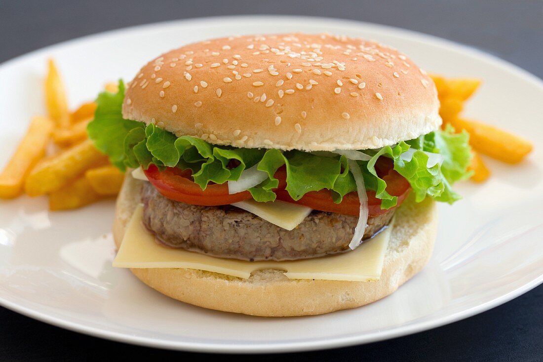 A cheeseburger with tomatoes and lettuce