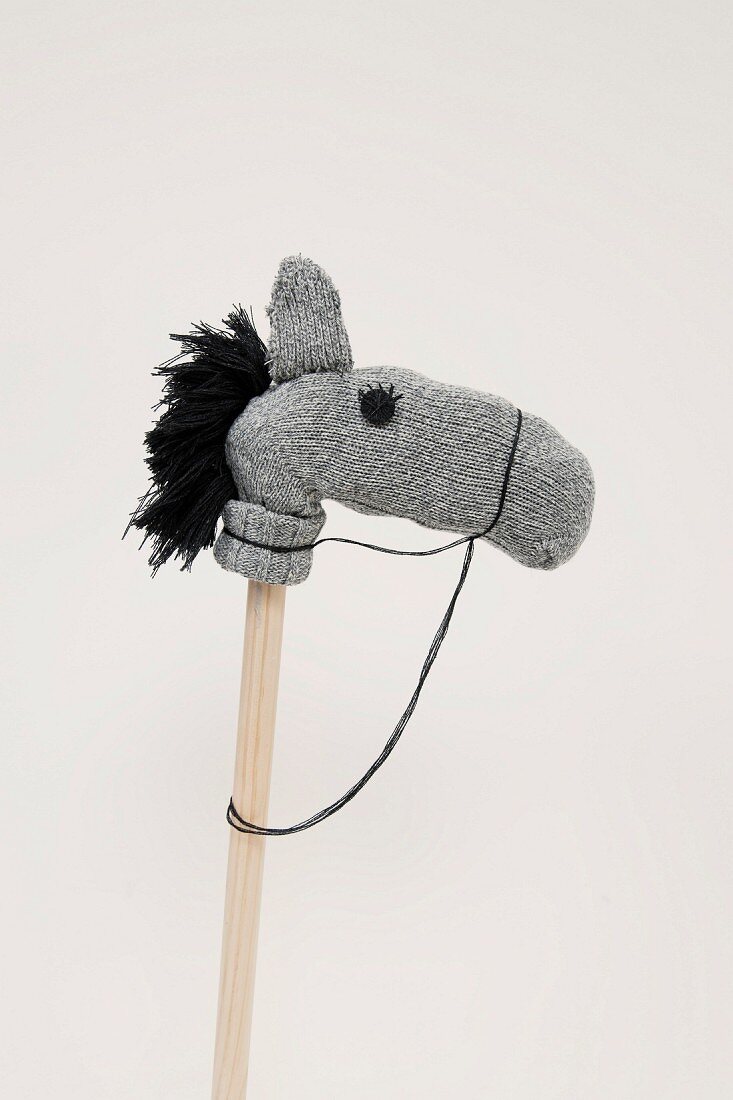 Hobbyhorse made from grey woollen socks with black wool mane