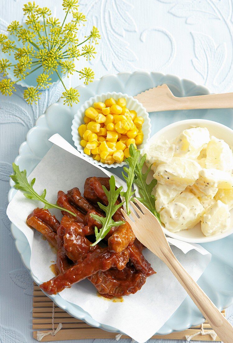 Spicy marinated steak strips with potatoes and sweetcorn