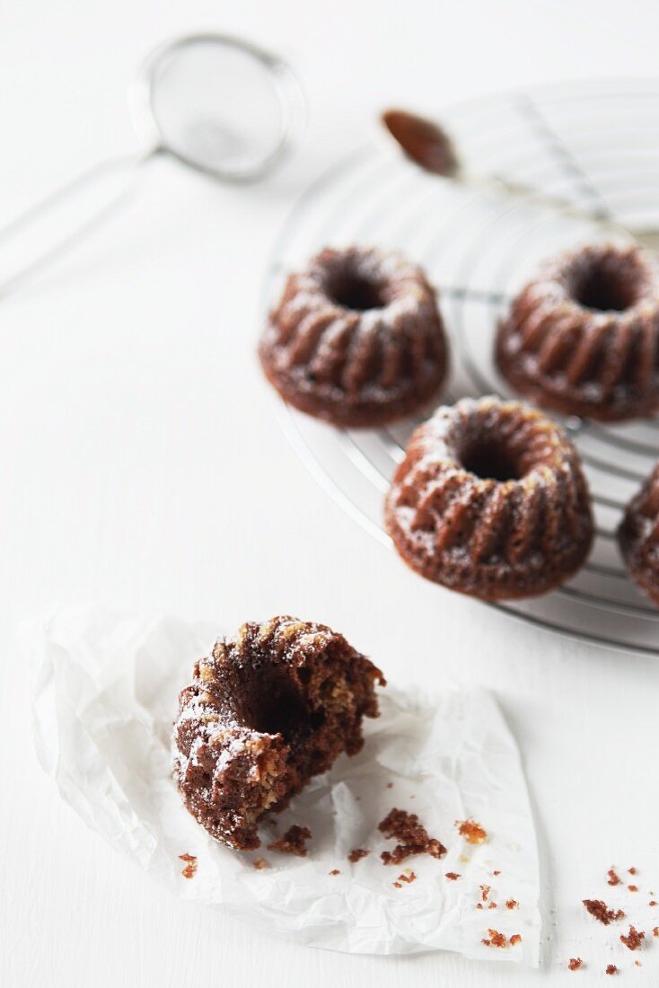 Bundt cakes on a wire rack and in front of it