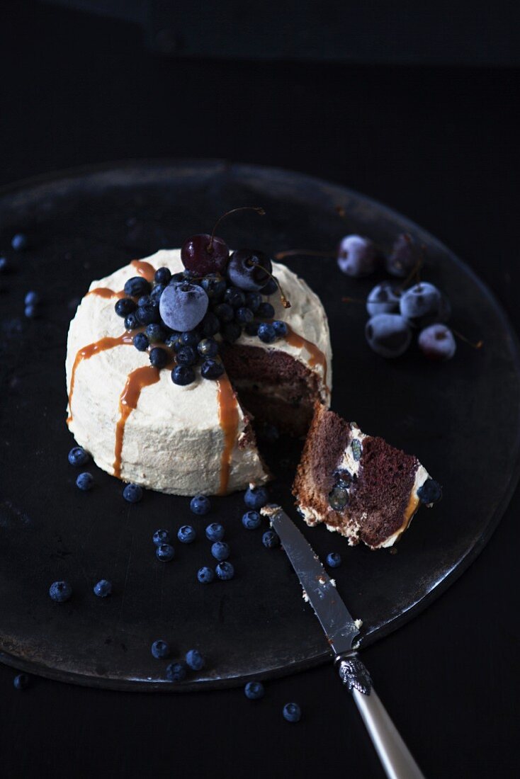 A sliced caramel and blueberry cake