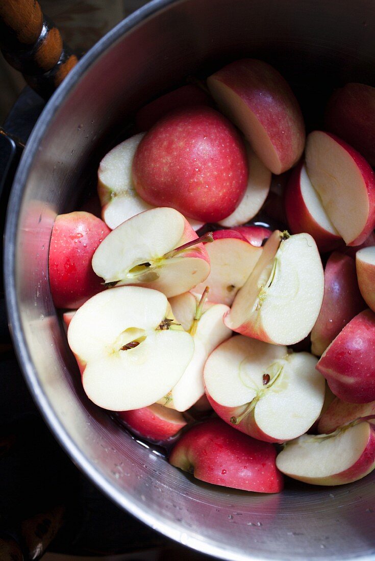 Halved apples in a metal bowl