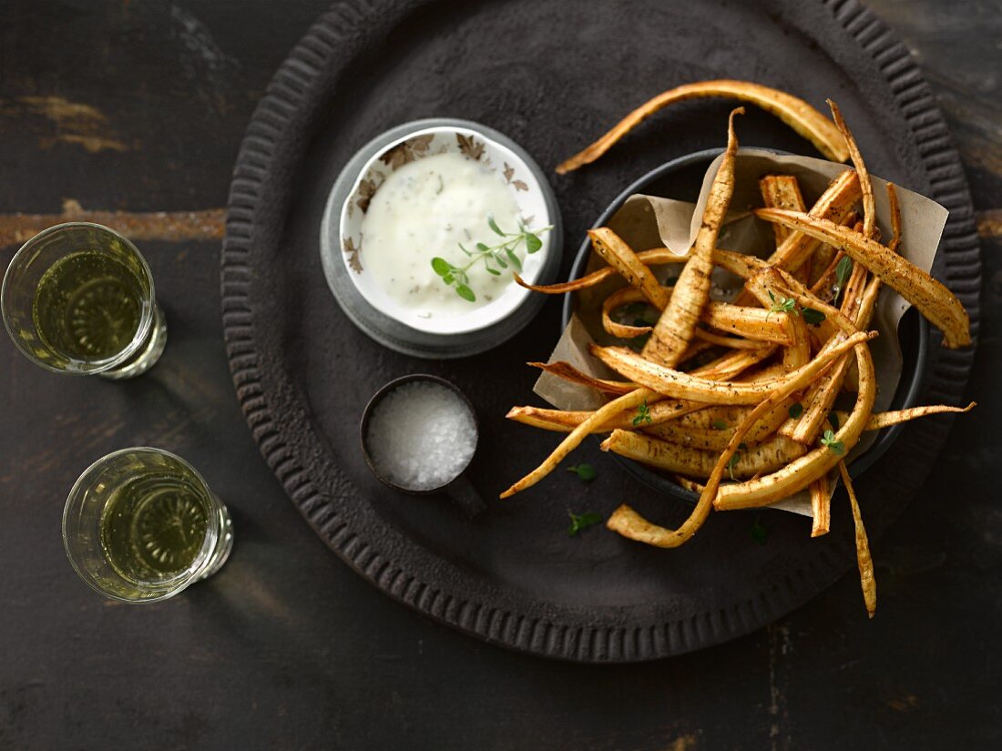 Fried parsnip with salt and pepper served with aioli and white wine