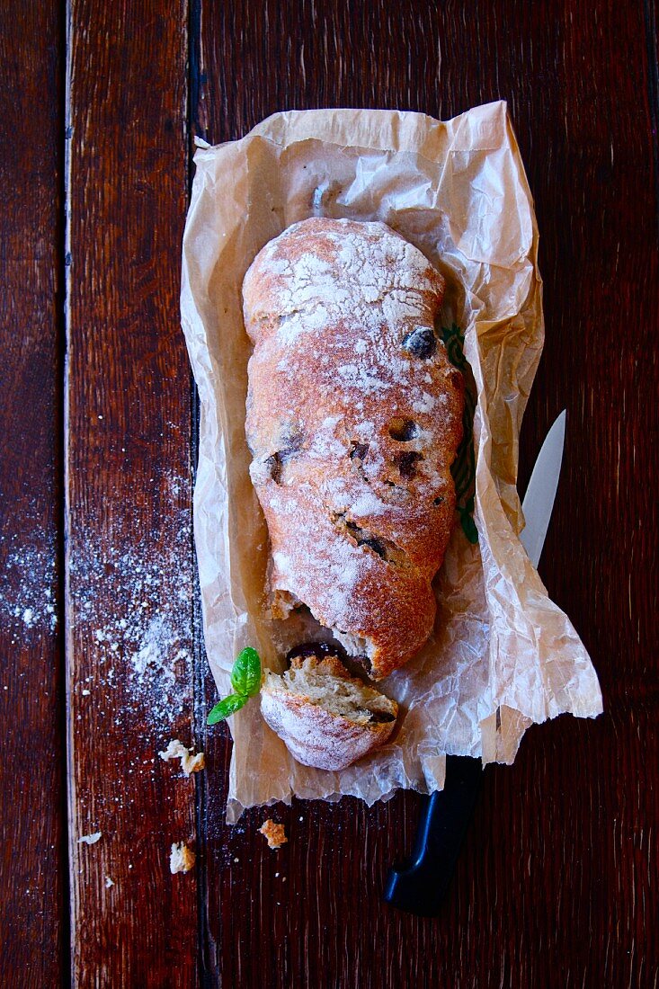 Ciabatta with olives on parchment paper