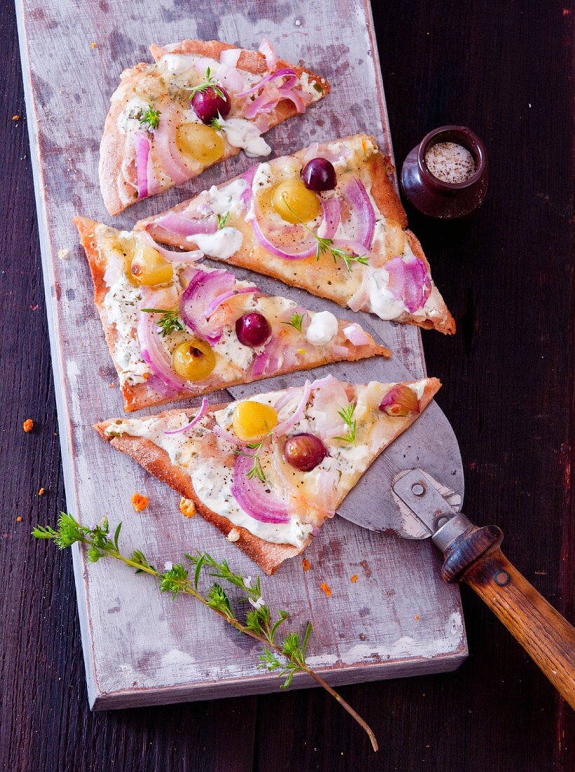 Tart flambée with red onions, grapes and thyme