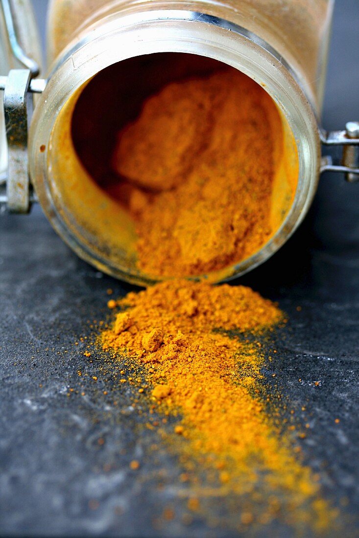 Turmeric powder in an opened glass jar