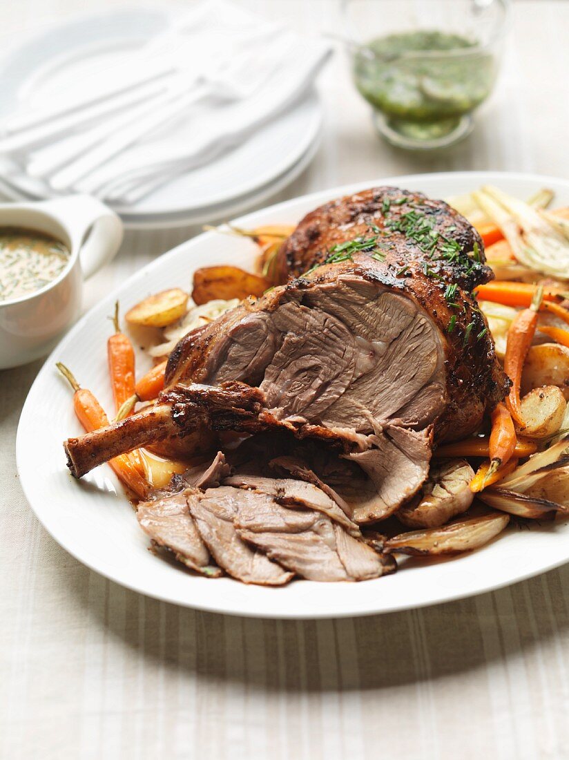 Roast lamb with root vegetables and a mint and caper sauce