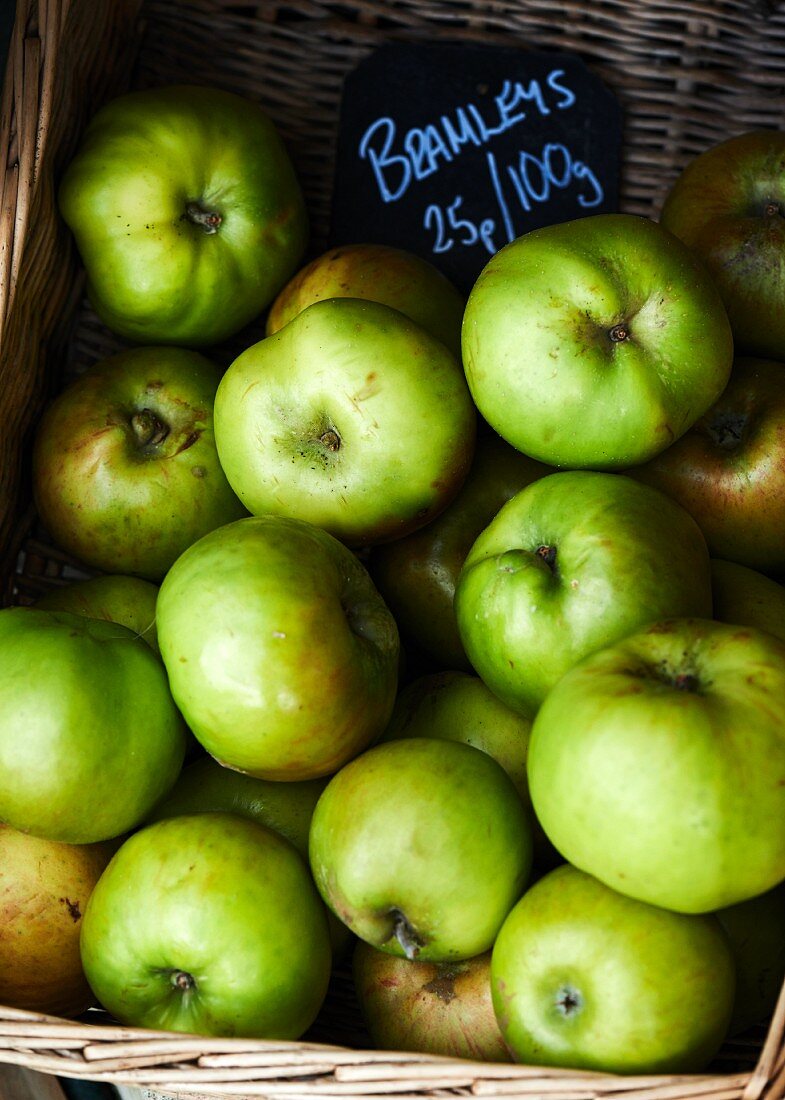 Green Bramley apples in a basket