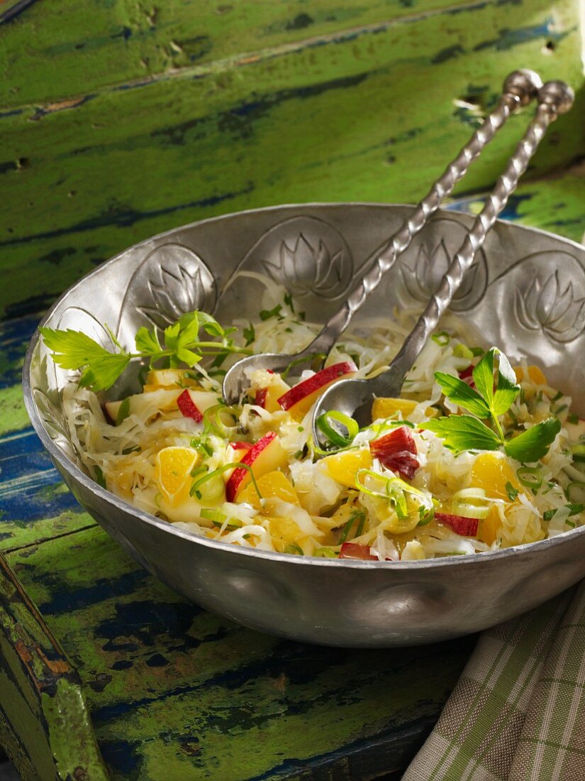 White cabbage salad with apples and oranges