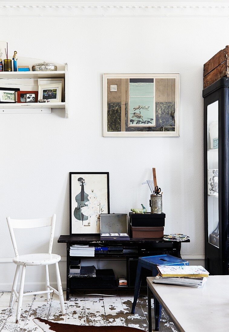 White-painted wooden chair and black shelves in vintage interior
