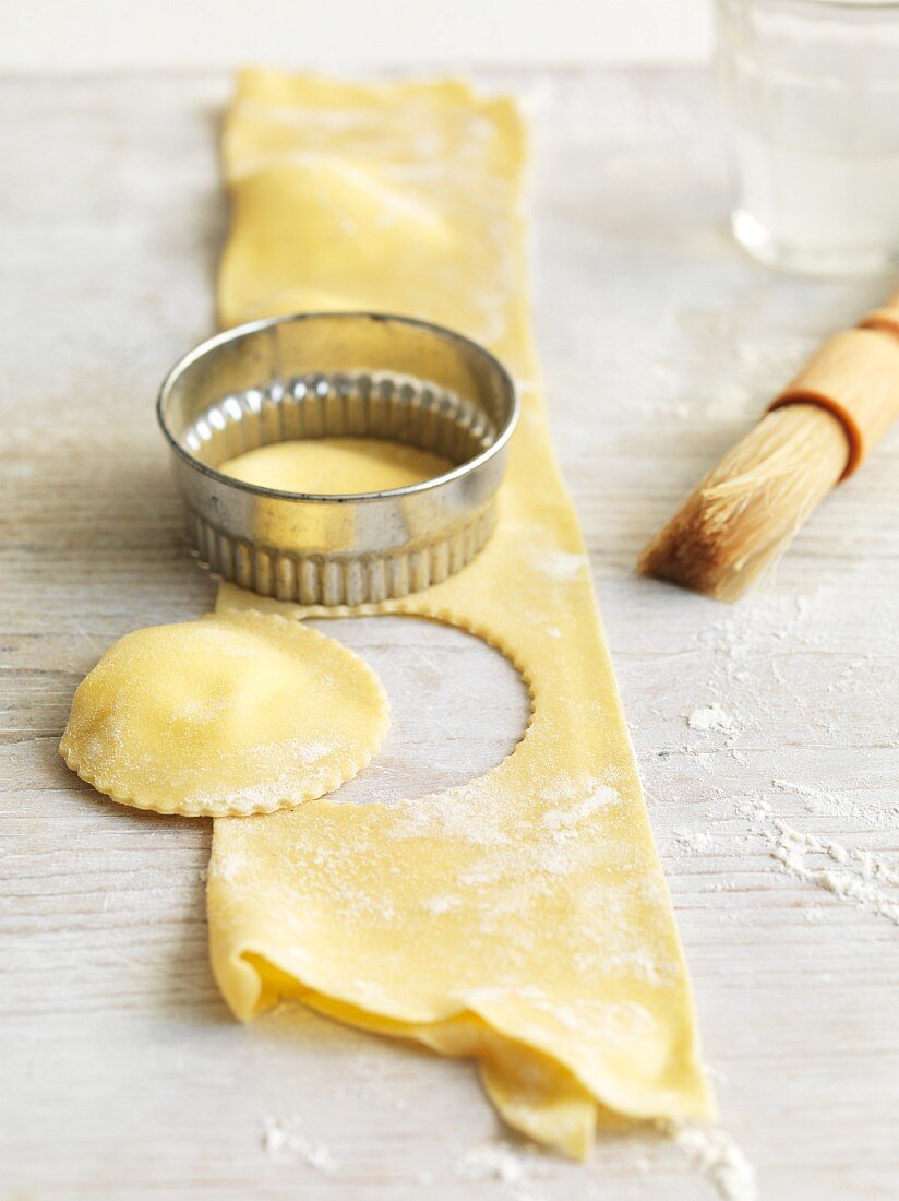 Pansotti (pasta parcels) with a ricotta filling being cut out