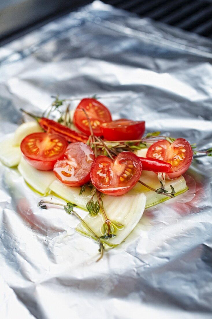 Cherry tomatoes and fennel on aluminium foil