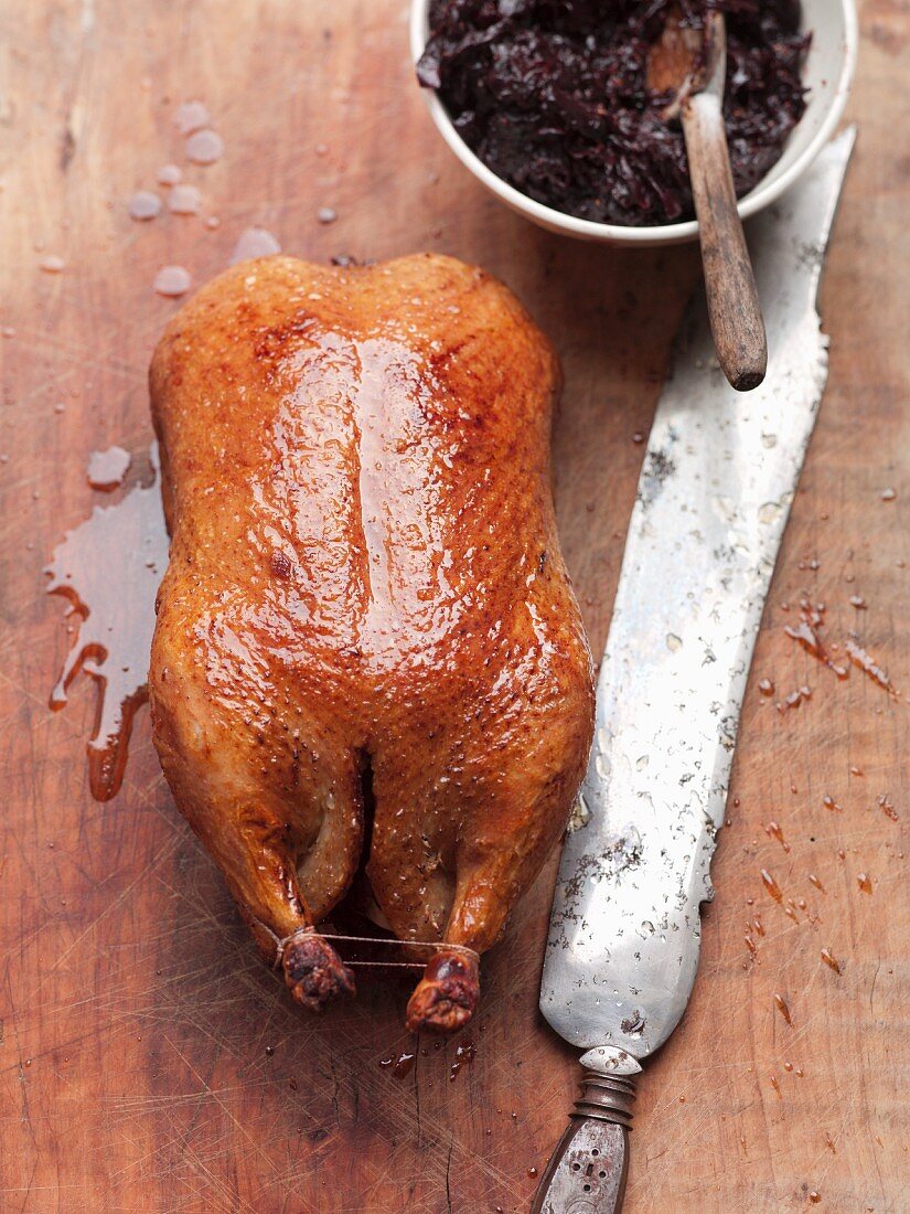 A whole roast duck with red cabbage