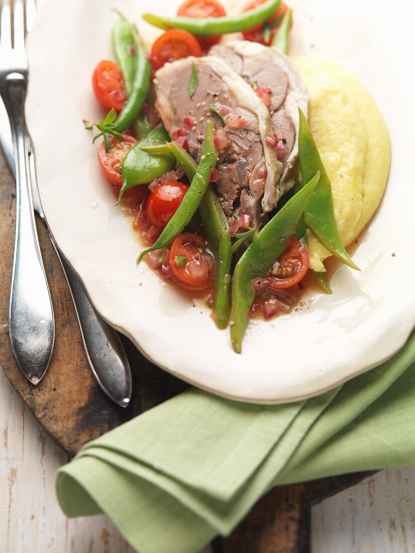 Boiled shoulder of lamb with beans, tomatoes and mashed potatoes