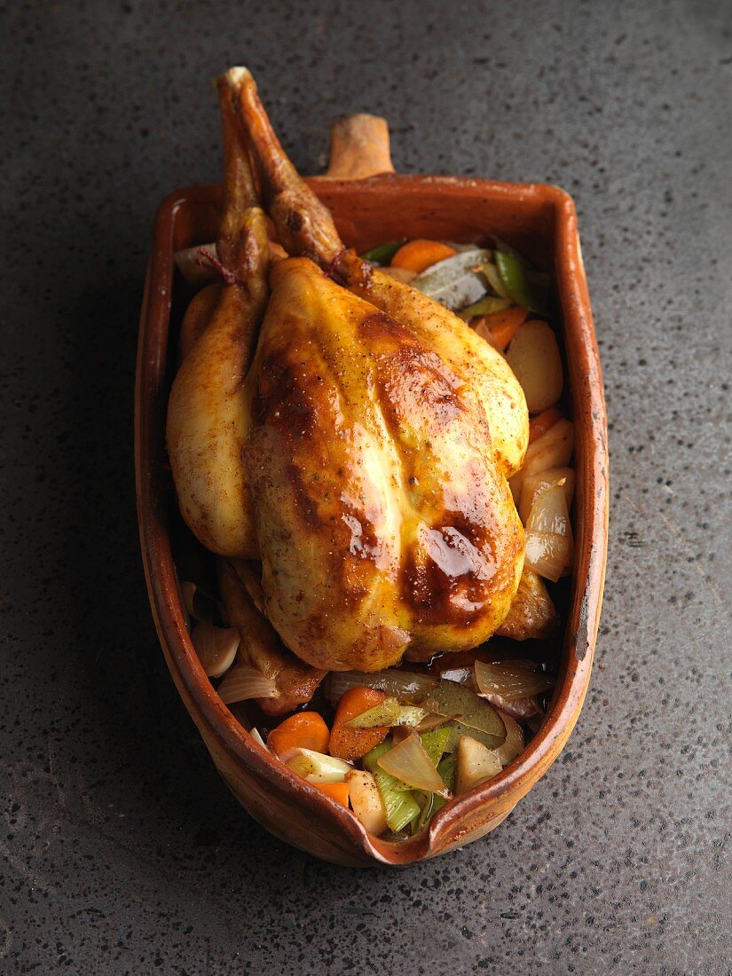 Roast chicken in a terracotta pot