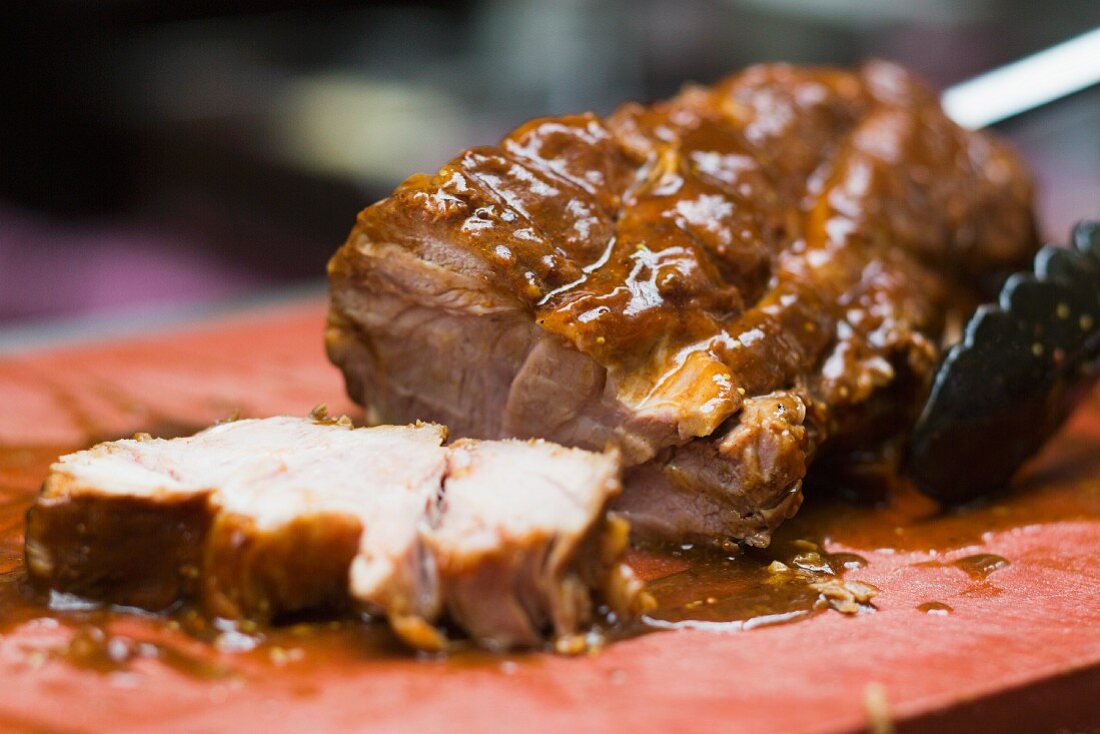Sliced roast pork on a chopping board
