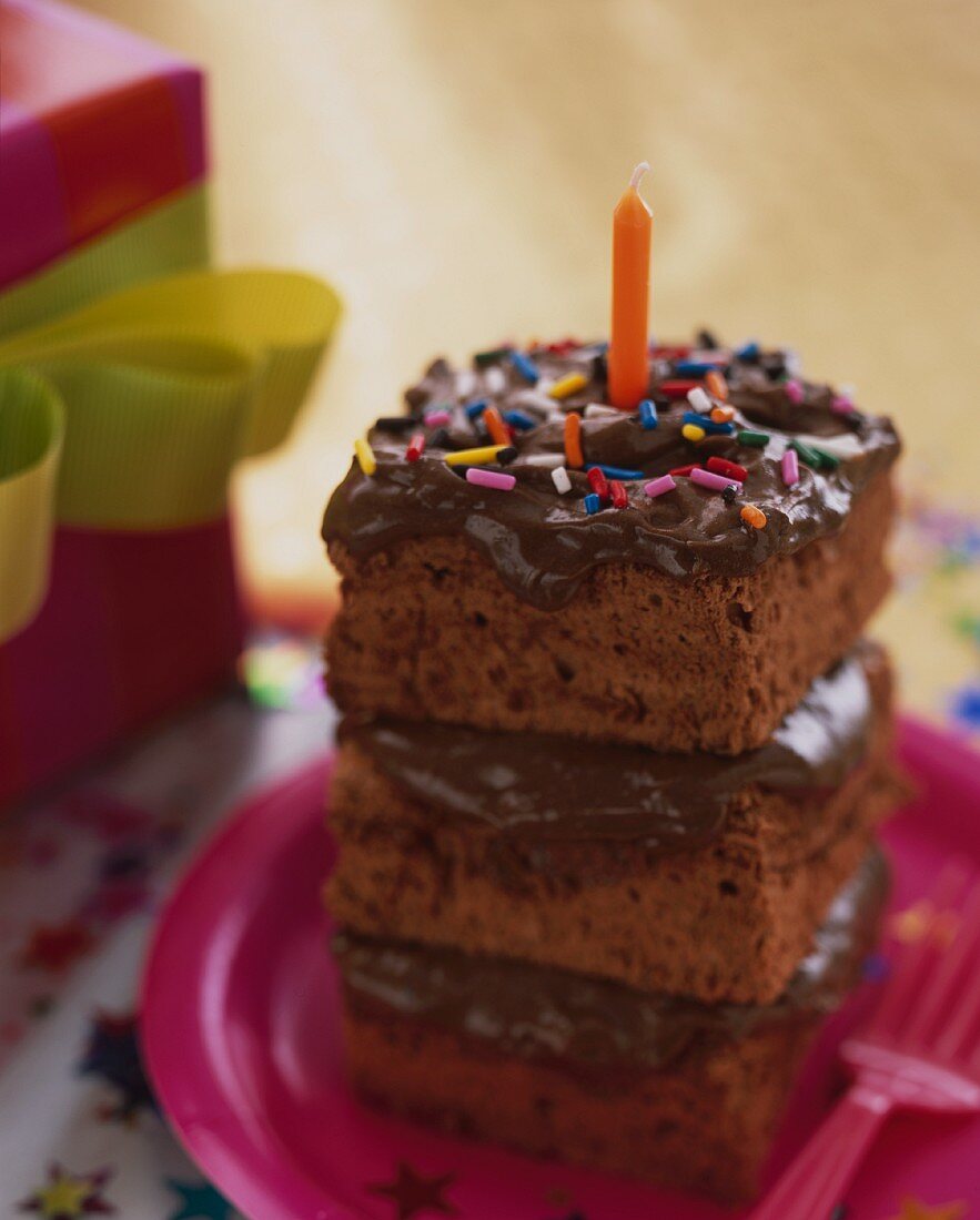 A stack of chocolate cake slices for a birthday