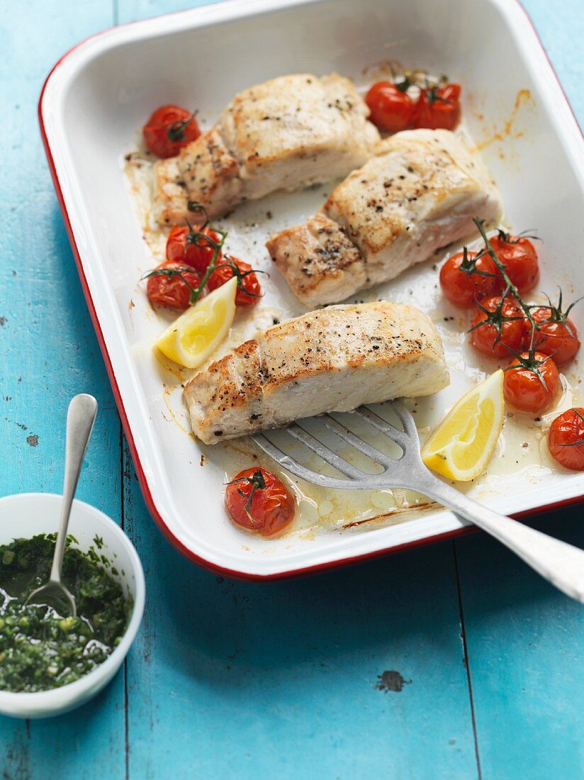 Oven-baked hake and cherry tomatoes with cucumber salsa