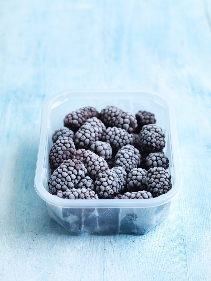 Frozen blackberries in a plastic punnet