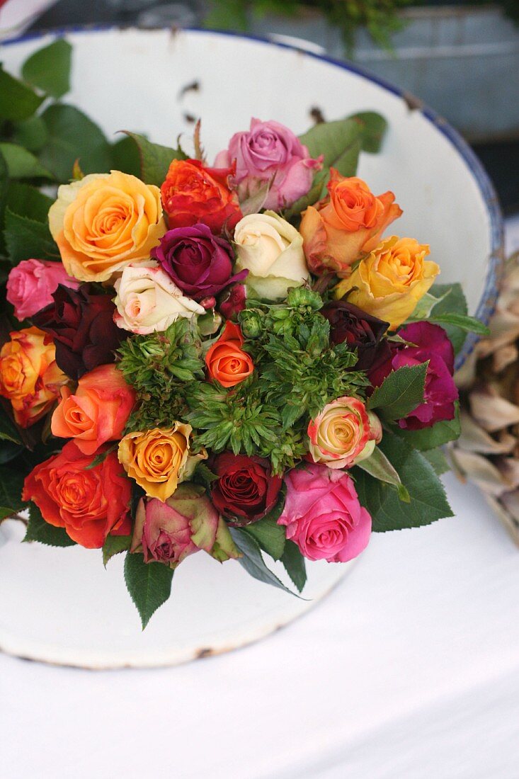 Enamel bowl of spray roses