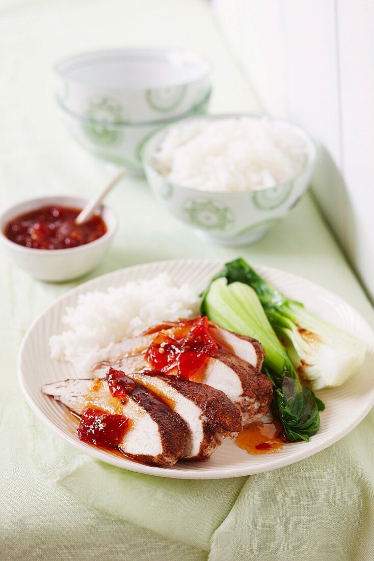 Fried chicken breast with chilli-tomato jam, pak choi and rice