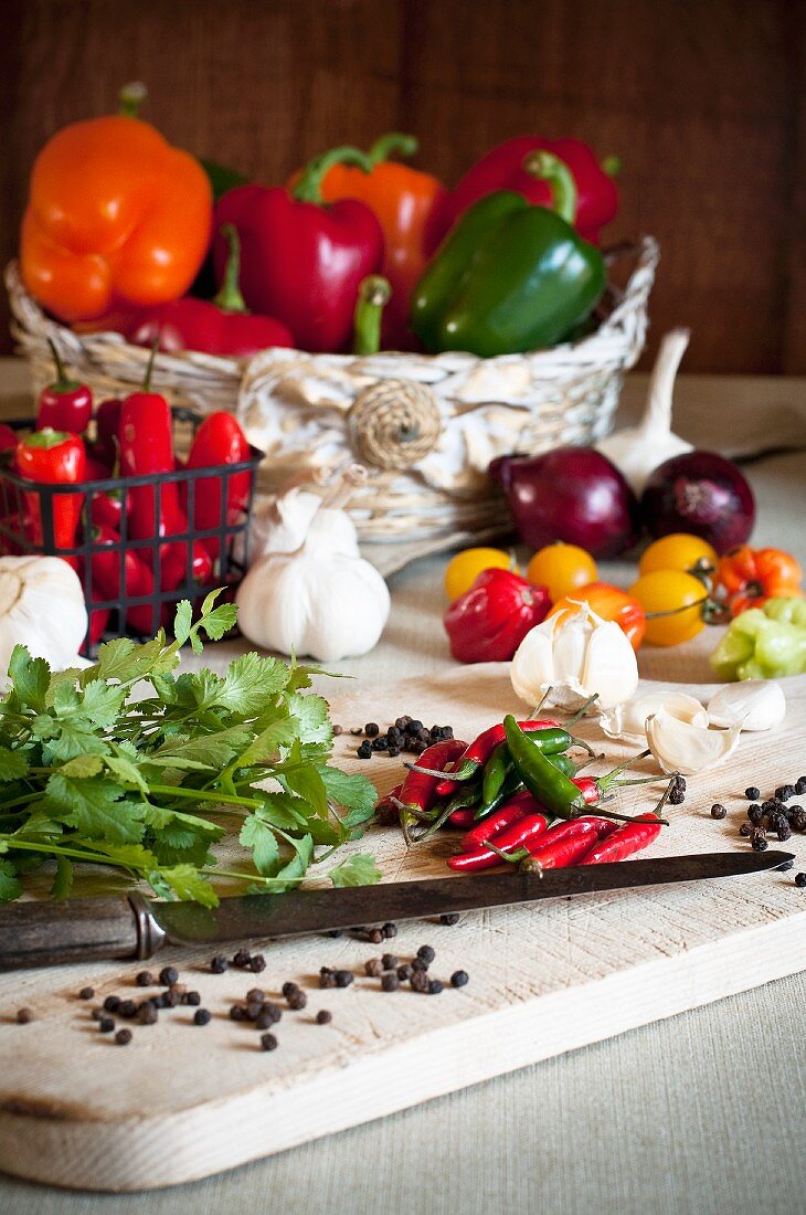 Gemüsestillleben mit Chilischoten, Tomaten, Paprika, Knoblauch, Koriandergrün und Pfeffer
