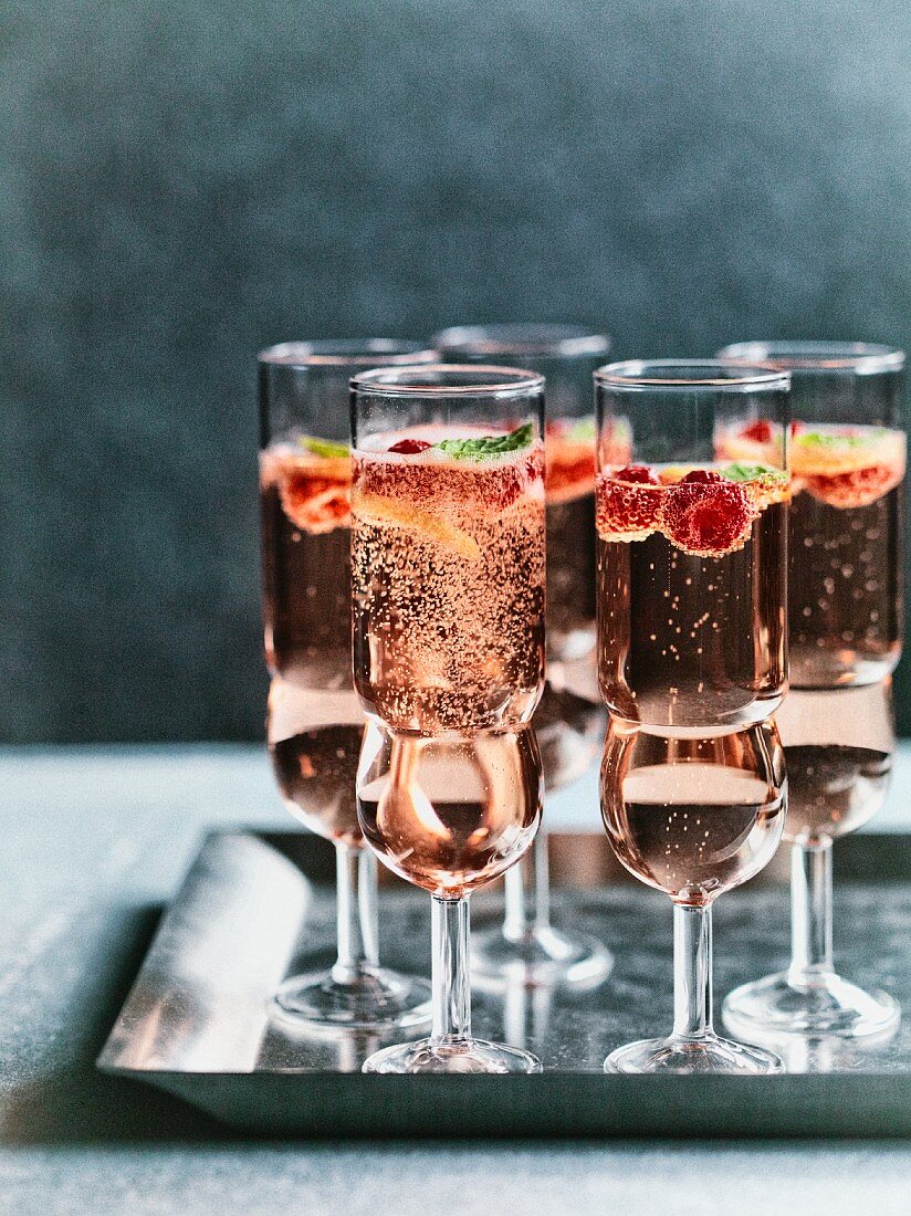 Glasses of rosé raspberry mint fizz on a metal tray