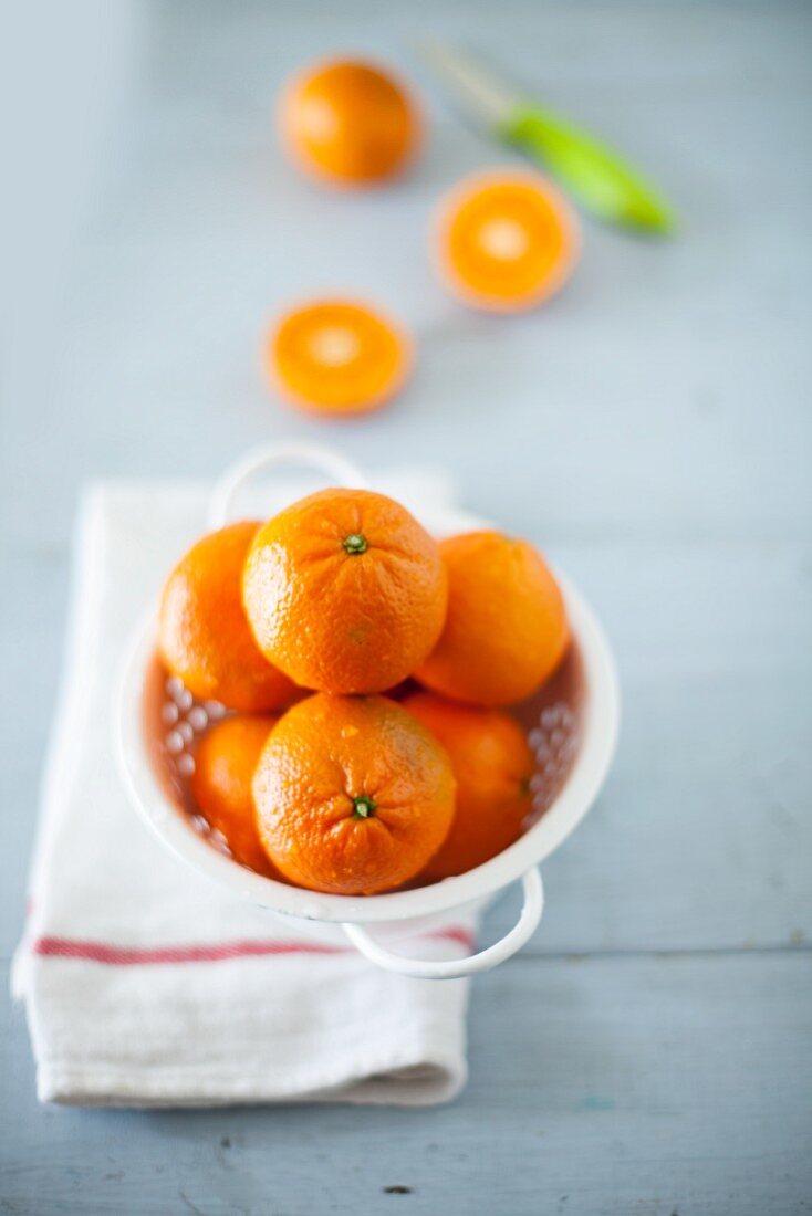 Fresh oranges in a colander