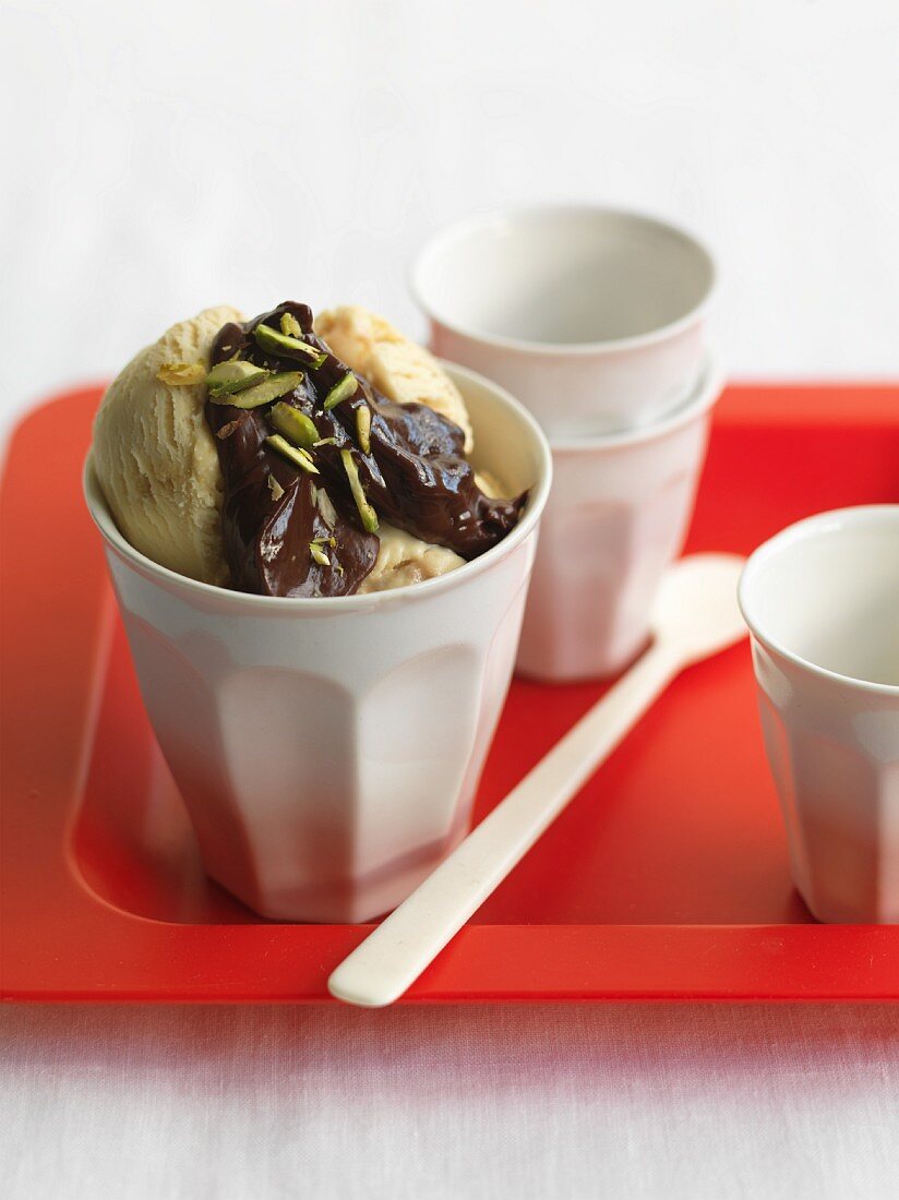 Vanilla ice cream with chocolate and coffee sauce and pistachios