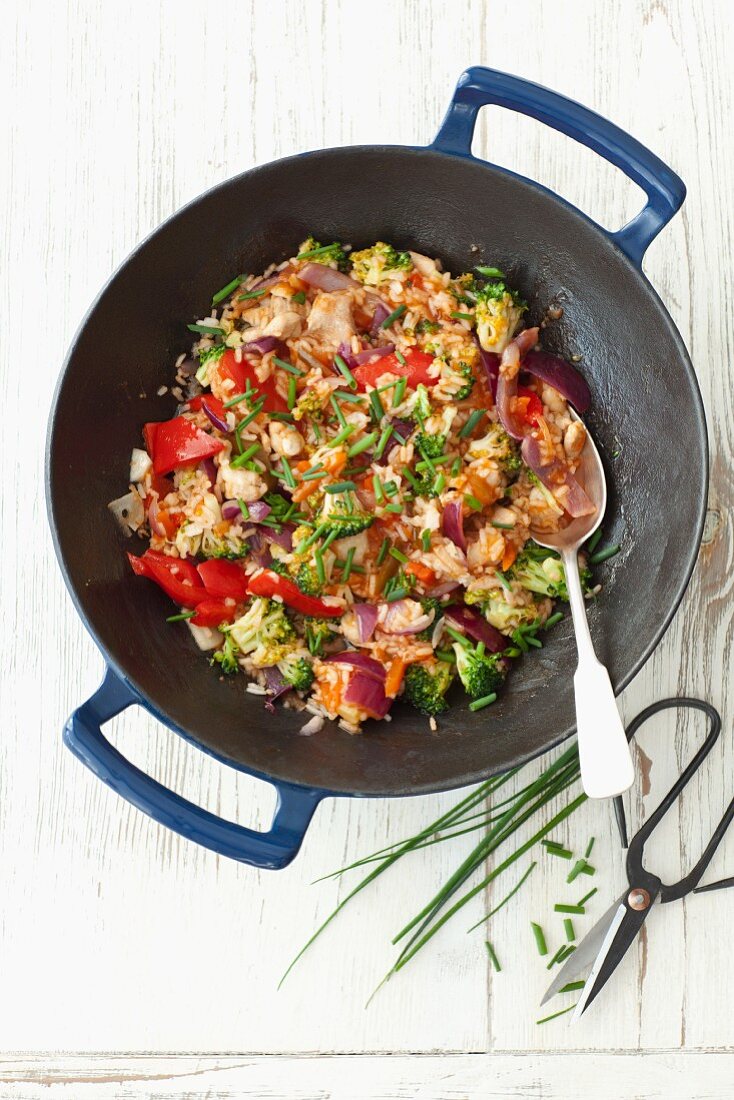 Fried rice with chicken, pepper, broccoli and red onions in a sweet-and-sour sauce