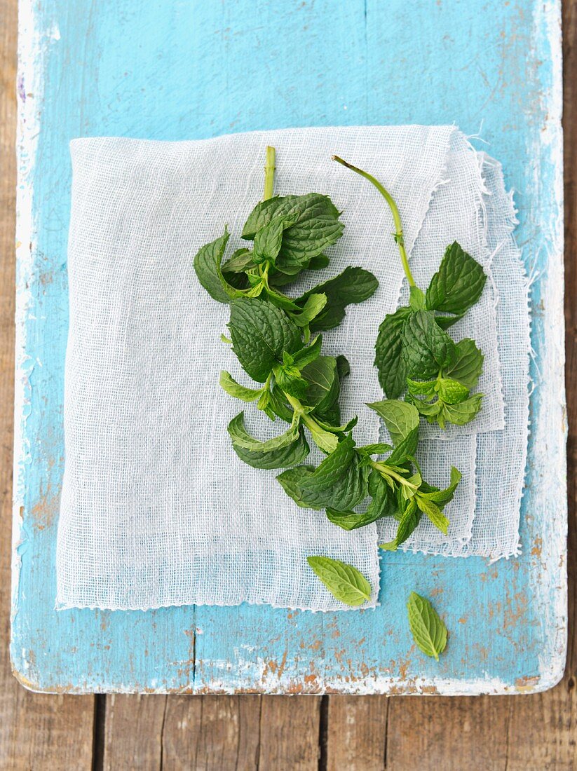 Fresh mint on a blue wooden board