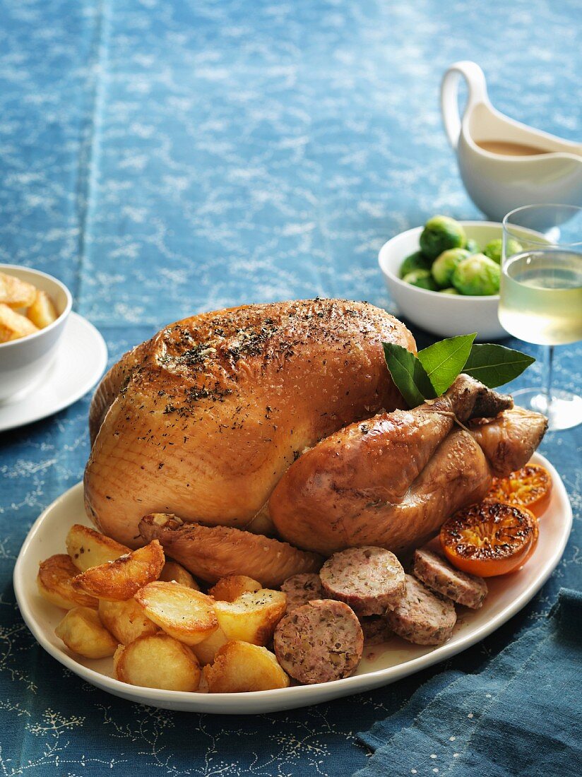 Roast turkey with a chestnut and sage stuffing served with roast potatoes and Brussels sprouts
