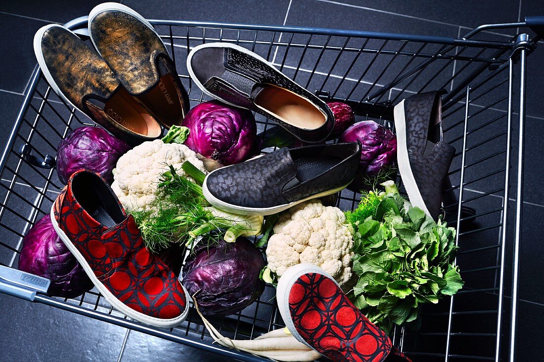 Various types of shoes and vegetables in a shopping trolley