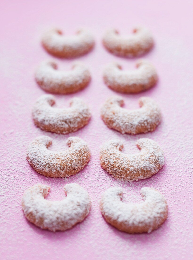 Two rows of vanilla crescent biscuits dusted with icing sugar