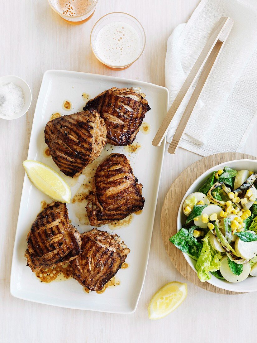 Charcoal-grilled chicken with potato and corn salad