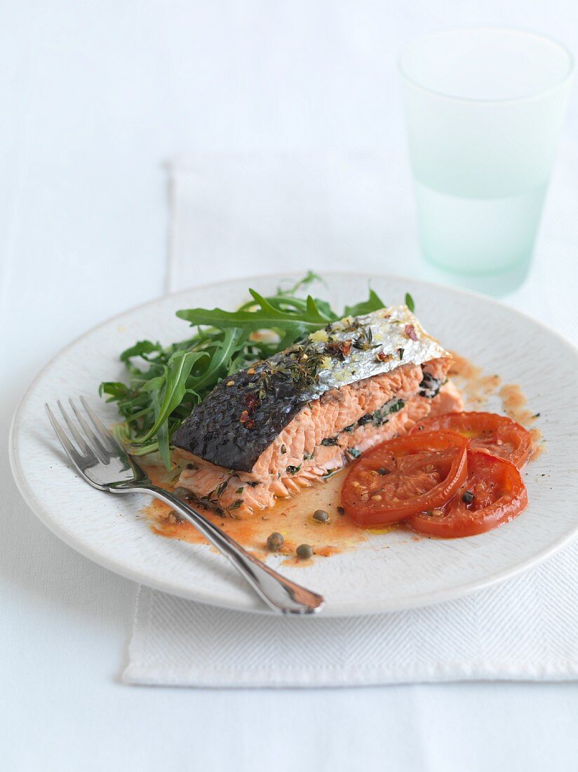 Stuffed salmon fillet with fried tomatoes and rocket