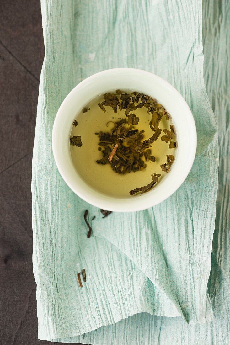A bowl of jasmine tea on Japanese paper