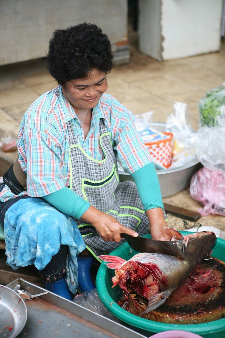 Fish being jointed at a market in Thailand