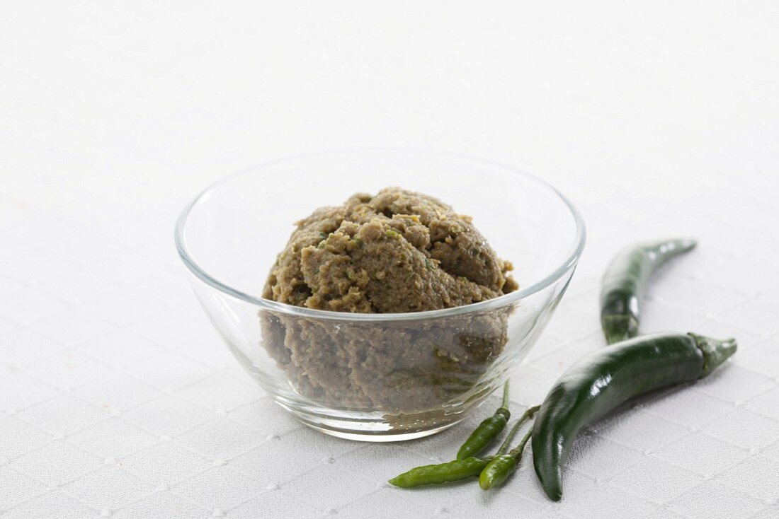Green curry paste and green chilli peppers