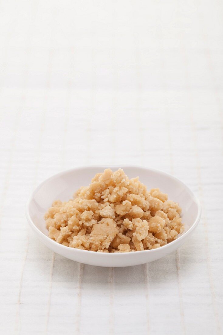 Palm sugar in a white bowl