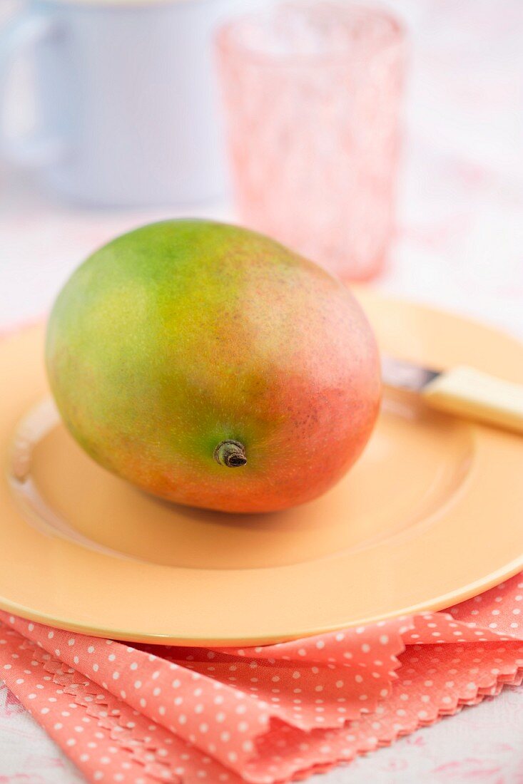 A fresh mango on a plate