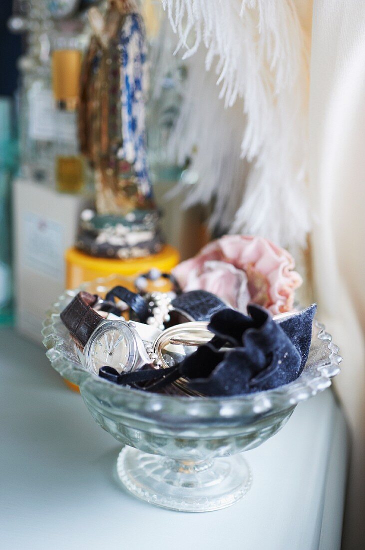 Watch and jewellery in glass bowl