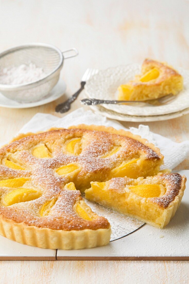 Peach and frangipani tart with powdered sugar