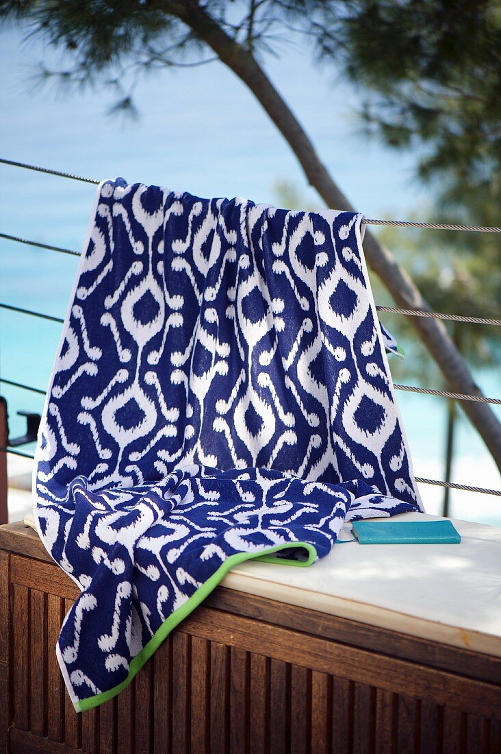 White and blue ikat cloth hung over balustrade