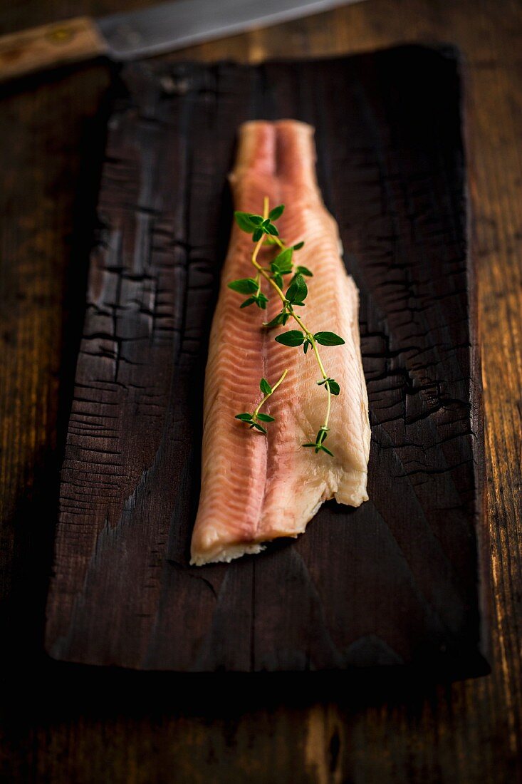 Smoked char on a wooden plank