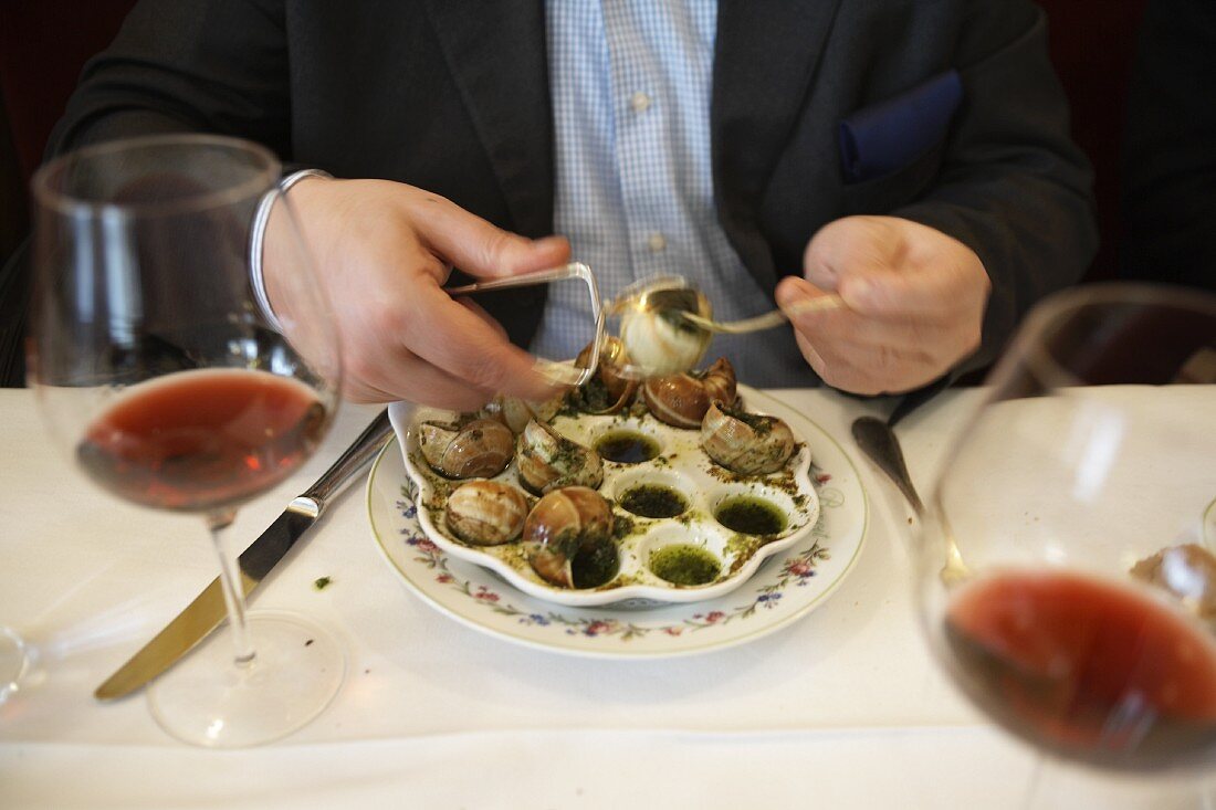 A man eating snails
