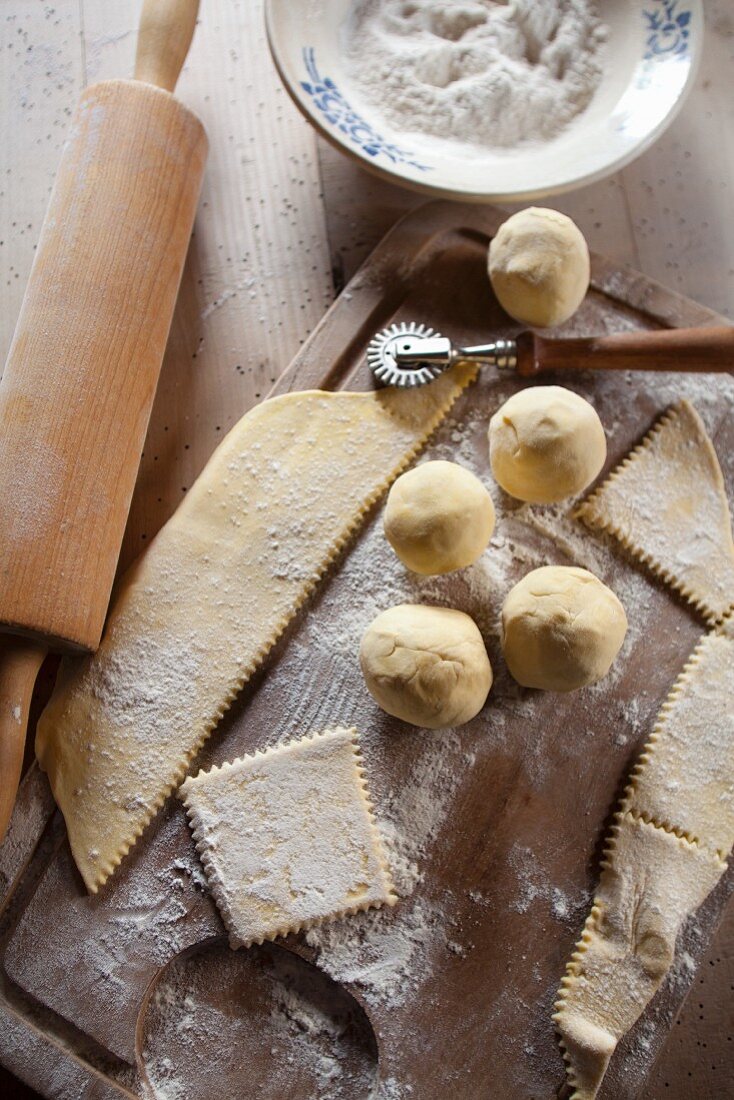 Dumpling dough, flour, a pastry cutter and a rolling pin