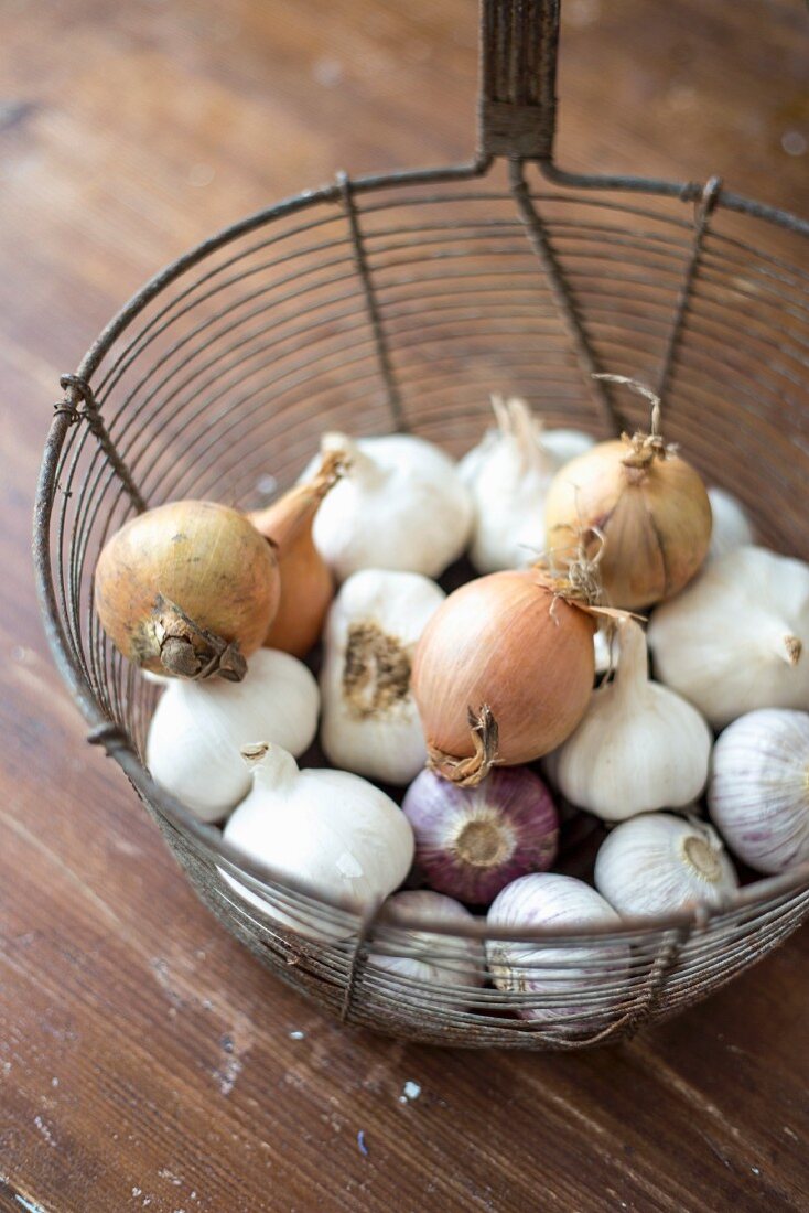 Old deep-frying basket used to store garlic & onions