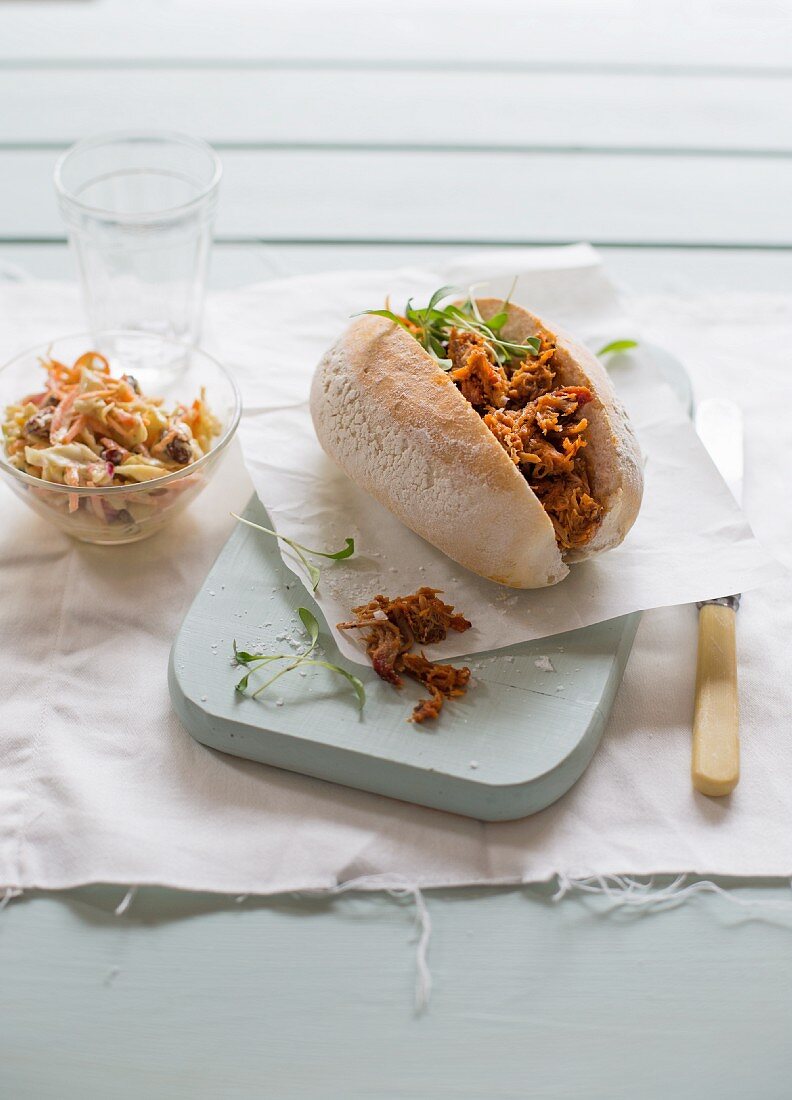 A pulled pork sandwich with cress and coleslaw